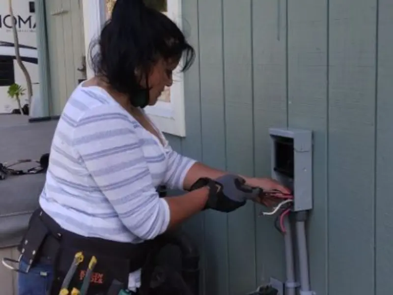 Licensed electrician wiring an exterior subpanel in Washington